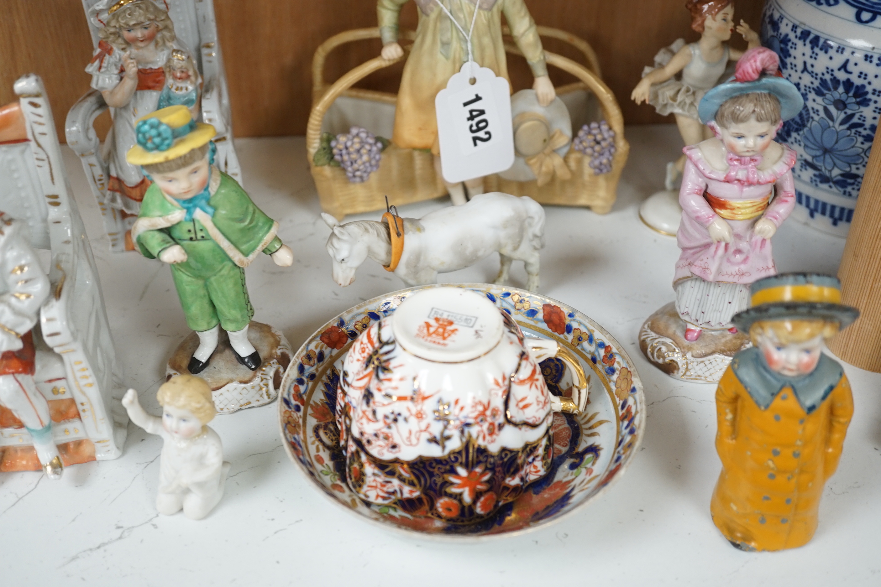 Twelve German and English porcelain items, mainly figures by Ernst Bohn, etc. a Staffordshire cup and saucer, blue and white vase, etc. vase 24cm